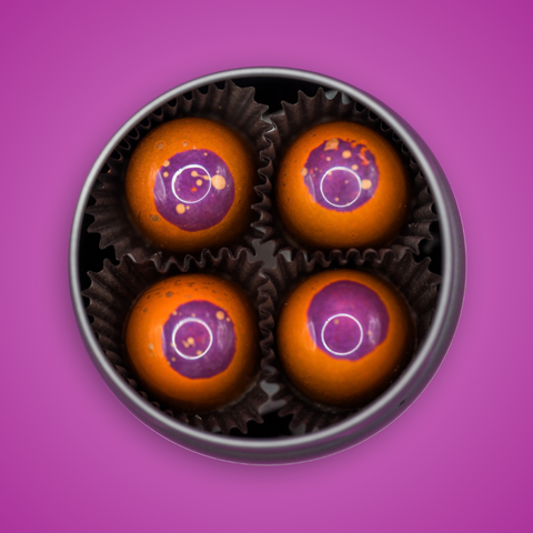 Appalachian Standard's limited edition Ross's Peanut Butter BonBons, eight packaged & airbrushed orange chocolates with purple tops in an open tin.