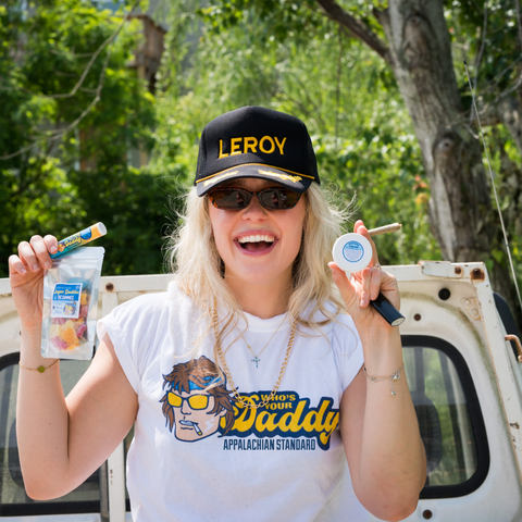Woman holding Sugar Daddies Altitude Adjusting Gummies packages outdoors - Appalachian Standards new product launch