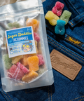 Appalachian Standard Sugar Daddies 30-pack THC gummies styled on denim wrangler jeans with gold chain and leather wallet for Father's Day.