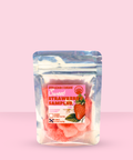 Packaged strawberry product with a pink label on a pink background