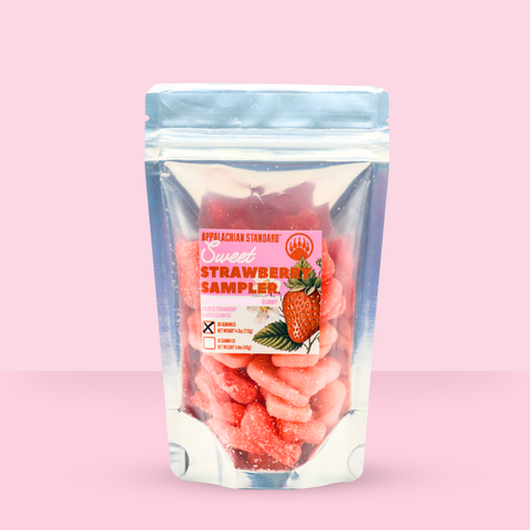 Strawberry gummy sampler package on a pink background