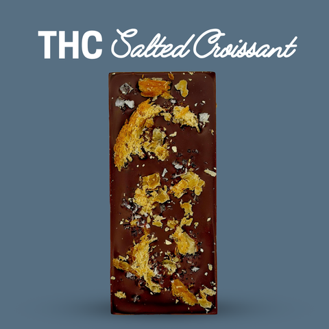 Chocolate bar with salted croissant pieces on a blue background, labeled 'THC Salted Croissant'.