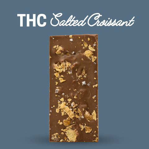 Appalachian Standard Salted Croissant THC Chocolate bar with gold flakes on a blue background.
