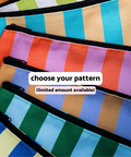 Six colorful striped zip pouches in assorted patterns — green and white, blue and tan, orange and lavender, periwinkle and brown, light blue and green, dark blue and yellow — available with the Appalachian Standard Main Squeeze Skincare Bundle, limited quantities available.