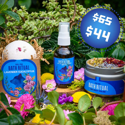 Three of Appalachian Standard's products on display with a nature backdrop: the CBD bath bomb, CBD body oil, and CBD body polish