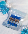 Clear plastic packaging with blue cylindrical items on a snowy background