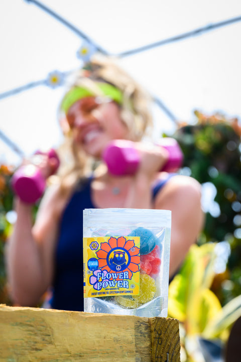 Woman exercising with dumbbells, with a 'Flower Power' product in the foreground.