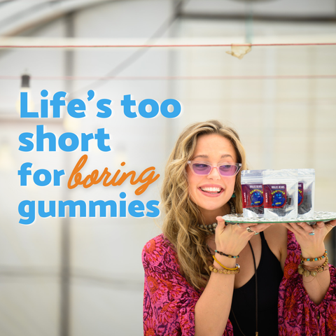 Woman holding two containers with text 'Life's too short for boring gummies' on a blurred background