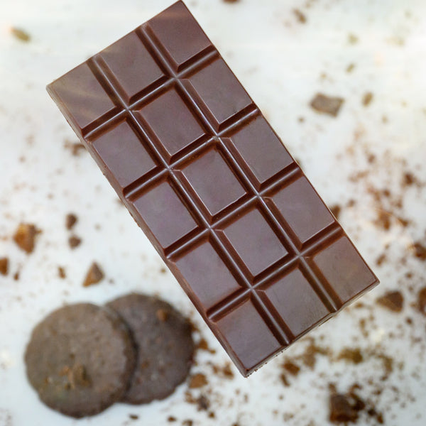 A bar of Appalachian Standard's Mint Chocolate Cookie CBD Chocolate with two mint chocolate cookies on the side