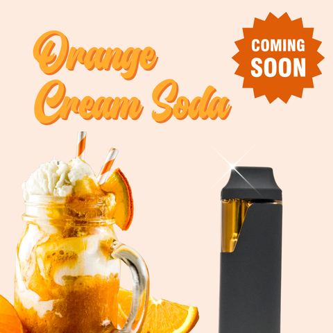 Appalachian Standard Orange Cream Soda vape pen in matte black, displayed alongside a mason jar orange cream soda float topped with vanilla ice cream, orange slices, and striped paper straws on a soft peach background. Orange script text reads "Orange Cream Soda" with a burnt orange "Coming Soon" badge in the upper right corner.