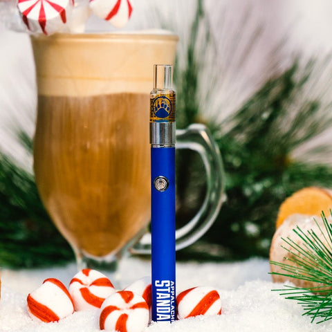 Christmas-themed drink with candy canes and a hot chocolate bomb on a snowy surface for Appalachian Standard's Vape.