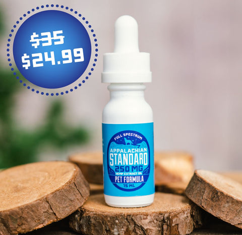 A 1 oz bottle of Appalachian Standard's Pet Formula Full Spectrum CBD Tincture sits on a piece of wood