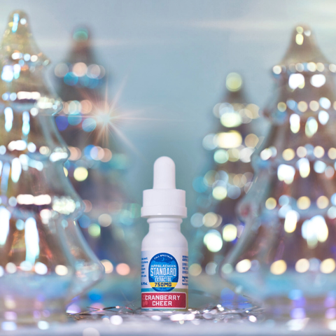 Bottle of Cranberry Cheer flavor with a blurred festive background
