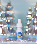Bottle of cinnamon-flavored vape juice with blurred Christmas trees in the background