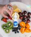 A bottle of Appalachian Standard's Tutti Frutti CBD Tincture surrounded by fruit