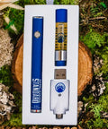 Appalachian Standard's Cherry Blossom CBD Vape kit in box on a wood slice surrounded by green moss