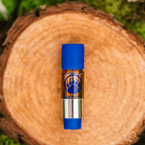 Appalachian Standard's Harle Cat CBD Vape cart on a wood slice